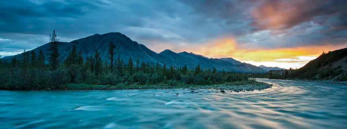 Image pf a remote wilderness river with mountain in the background