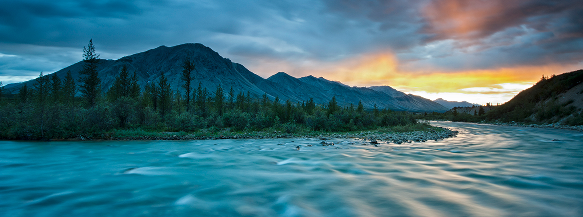 Image pf a remote wilderness river with mountain in the background